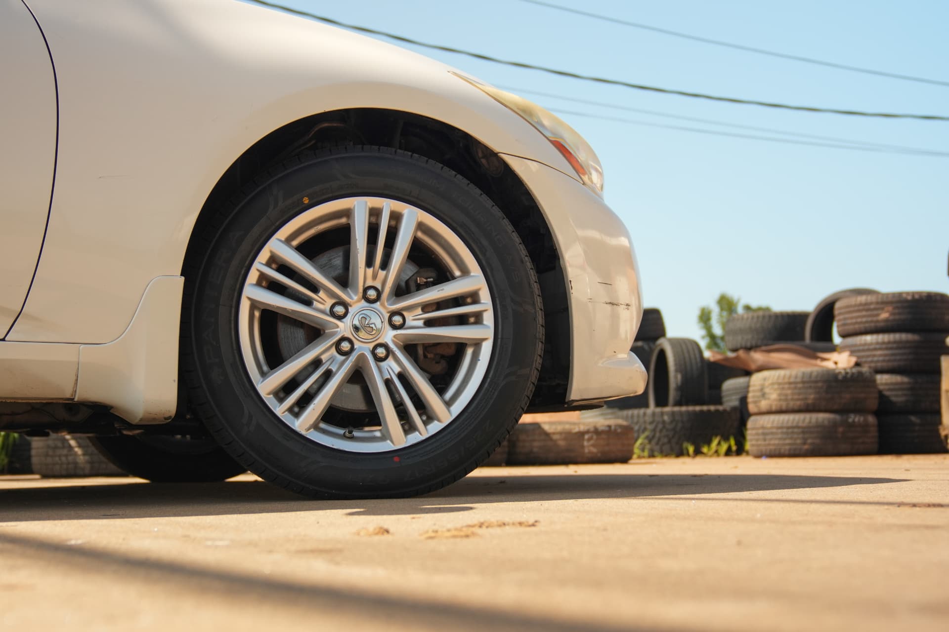 Car with a freshly mounted tire in the shop lot